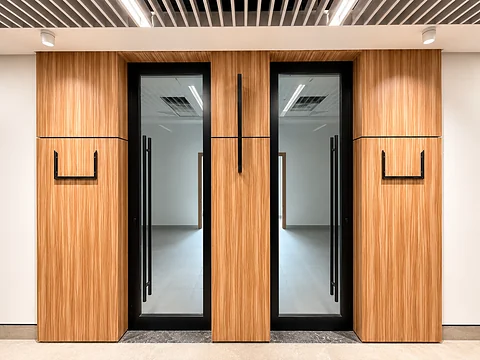 Double glazed doors set into a timber-panelled wall