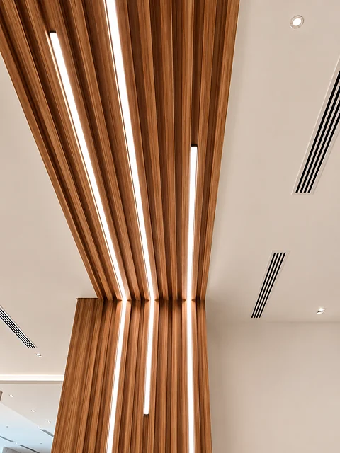 Curved timber slat ceiling with recessed linear lighting
