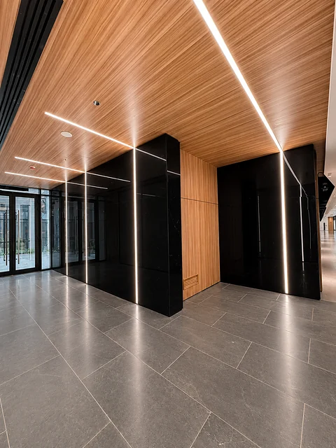 Wide hall with timber ceiling and glazed façade