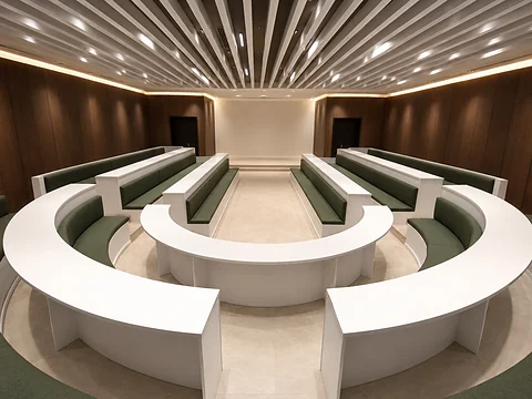 Completed council chamber with tiered seating and walnut wall panelling