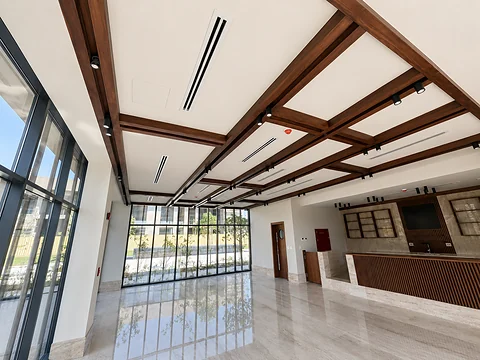 Hall with exposed timber beam ceiling and full-height glazing