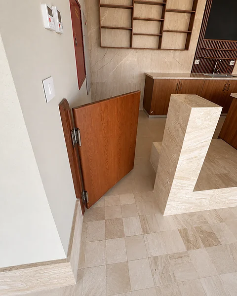 Timber cabinetry and display niches on a stone wall