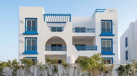 Three-storey residential façade with arched openings